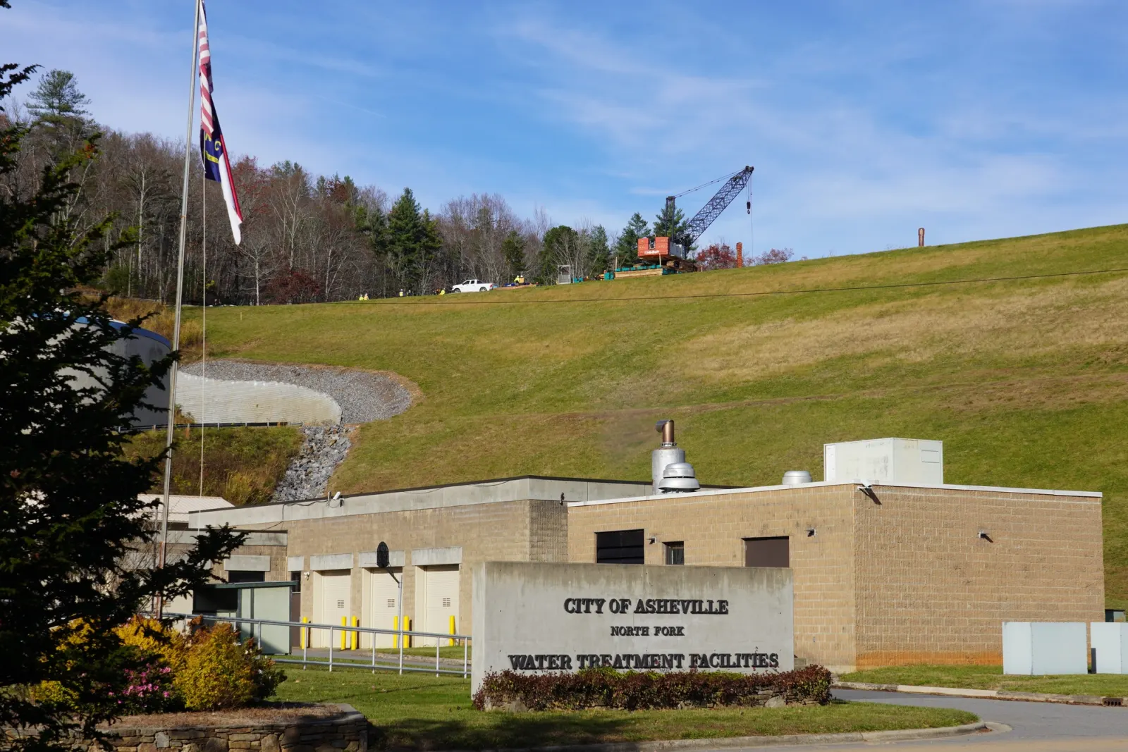 The North Fork water treatment facilities, with a crane working on the dam embankment behind them.